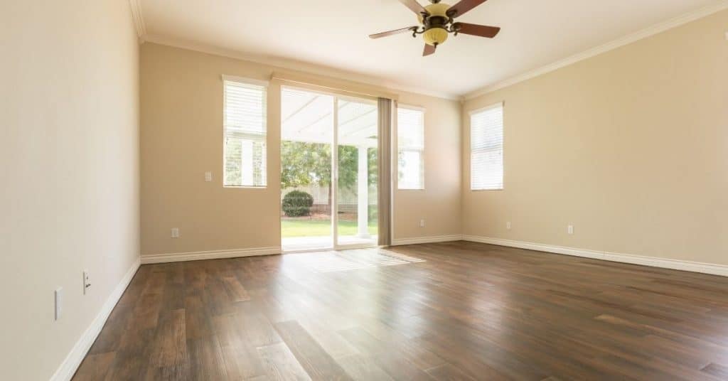 having the same flooring throught your home will make it look more cohesive and like one large area. Image of empty room with wood flooring